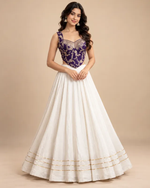 Ivory Lehenga with Purple Brocade Corset Choli — front view of the ivory skirt and purple brocade choli
