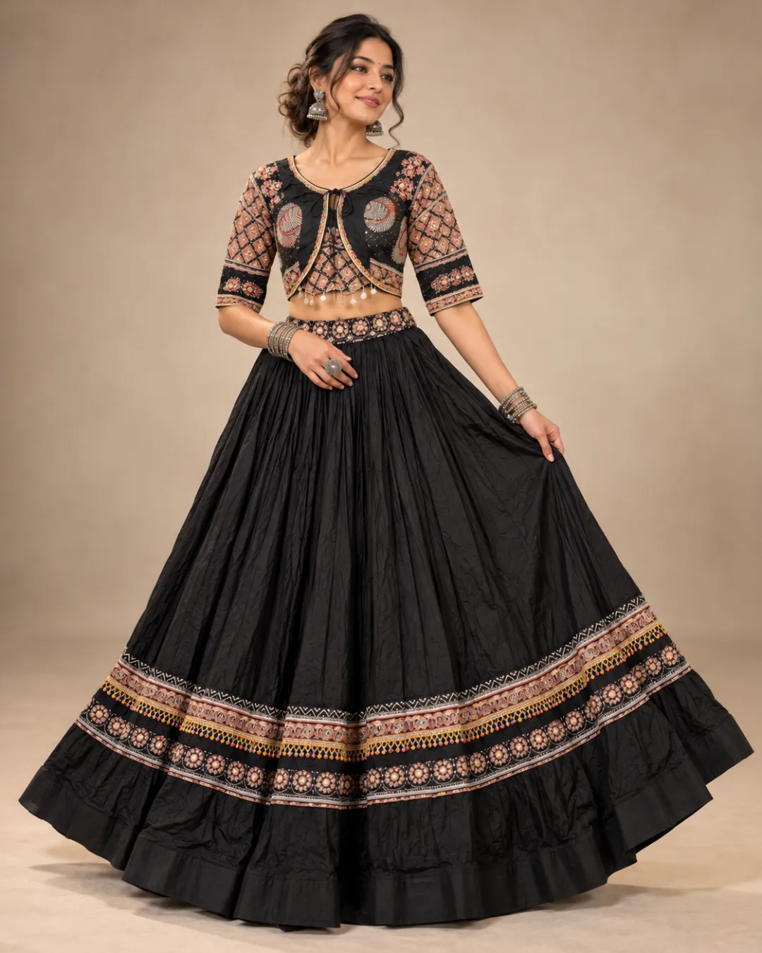 Black Gathered Lehenga with Printed Border and Jacket — skirt held open to show the printed hem bands