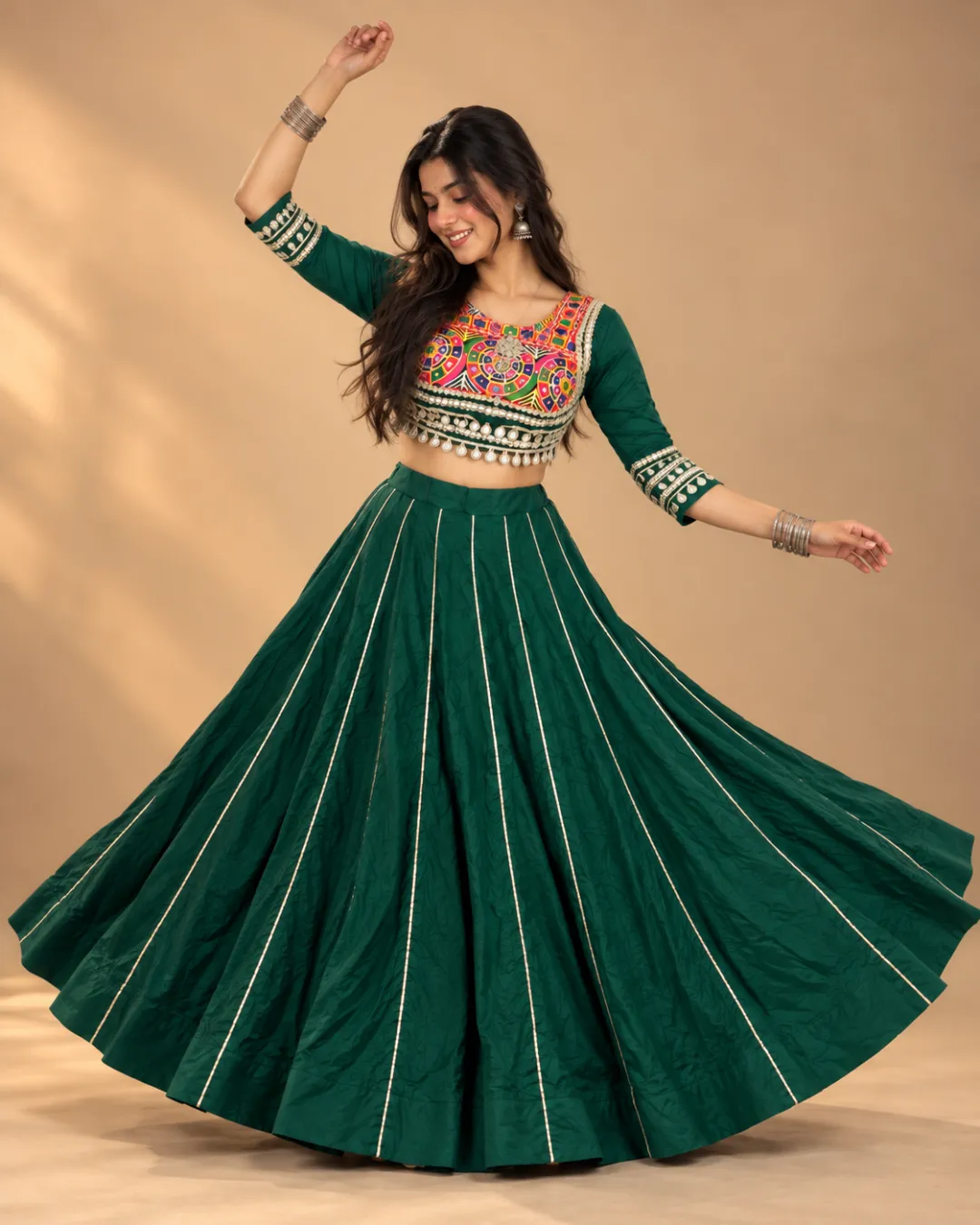 Emerald Green Panelled Lehenga with Embroidered Choli — mid-turn with the gold seam lines fanning out