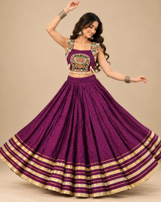 Plum Lehenga with Gold Zari Border and Embroidered Choli — mid-turn with the skirt open