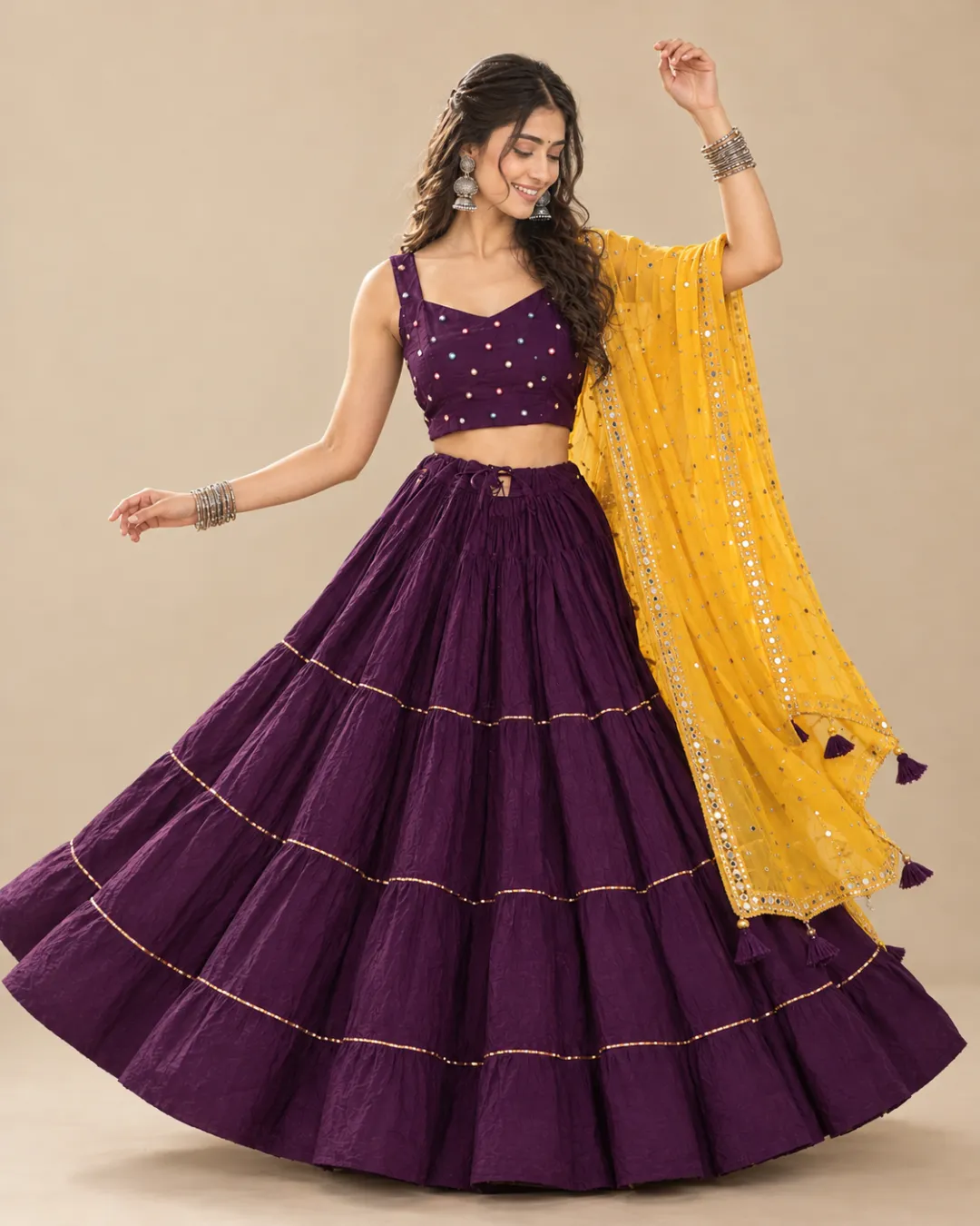 Purple Tiered Lehenga with Mustard Mirror Dupatta — mid-turn with the tiers opening out