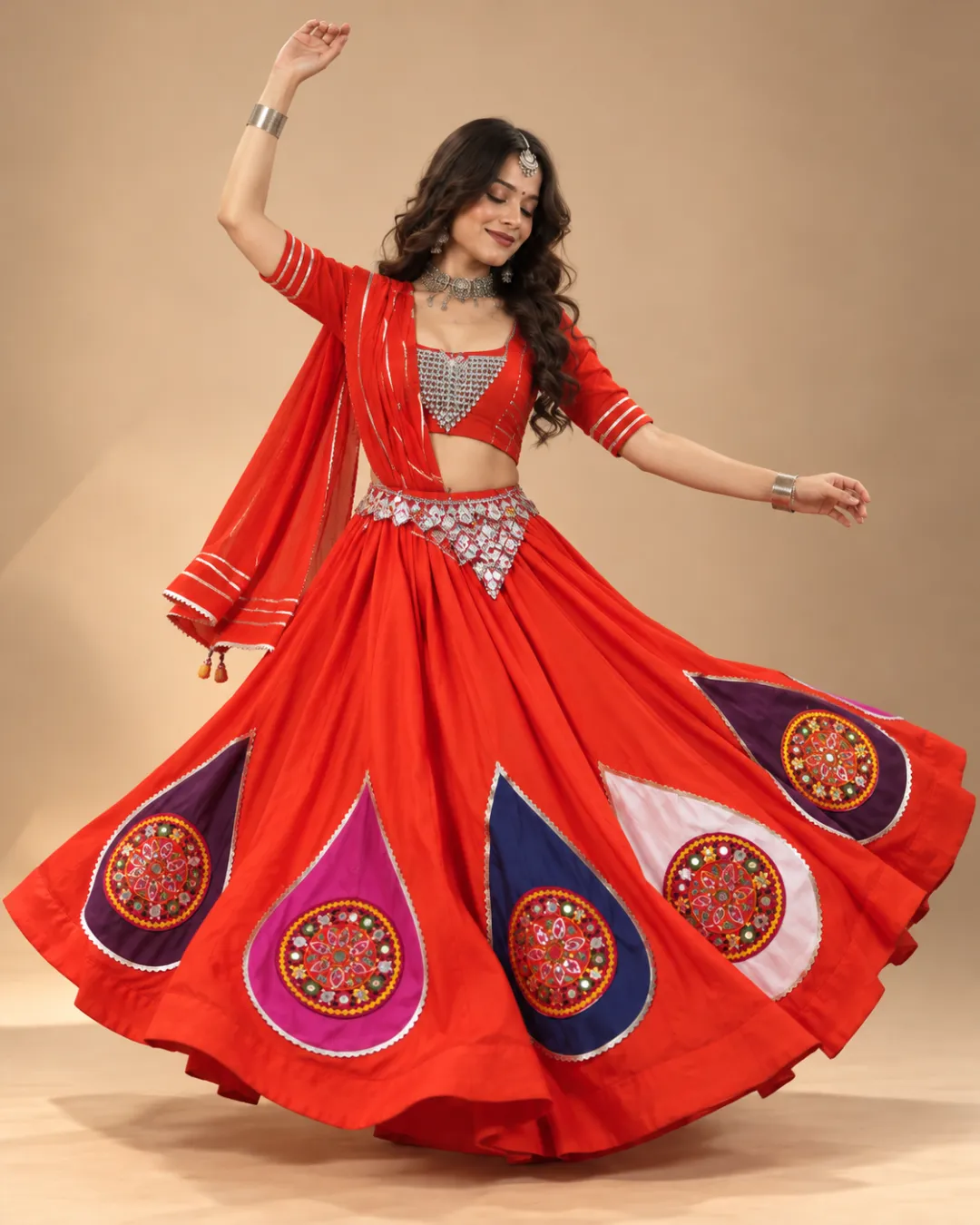 Orange-Red Lehenga with Mirror Teardrop Appliqué — mid-turn with the appliqués opening out