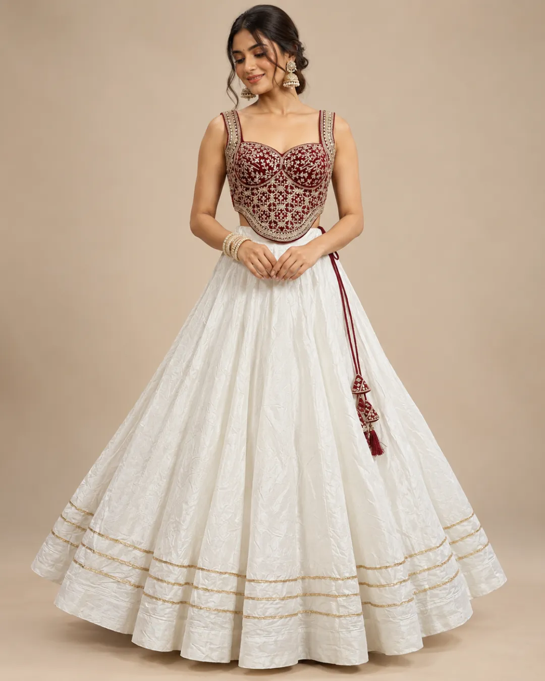 Ivory Lehenga with Maroon Embroidered Corset Choli — front view of the ivory skirt and maroon corset choli