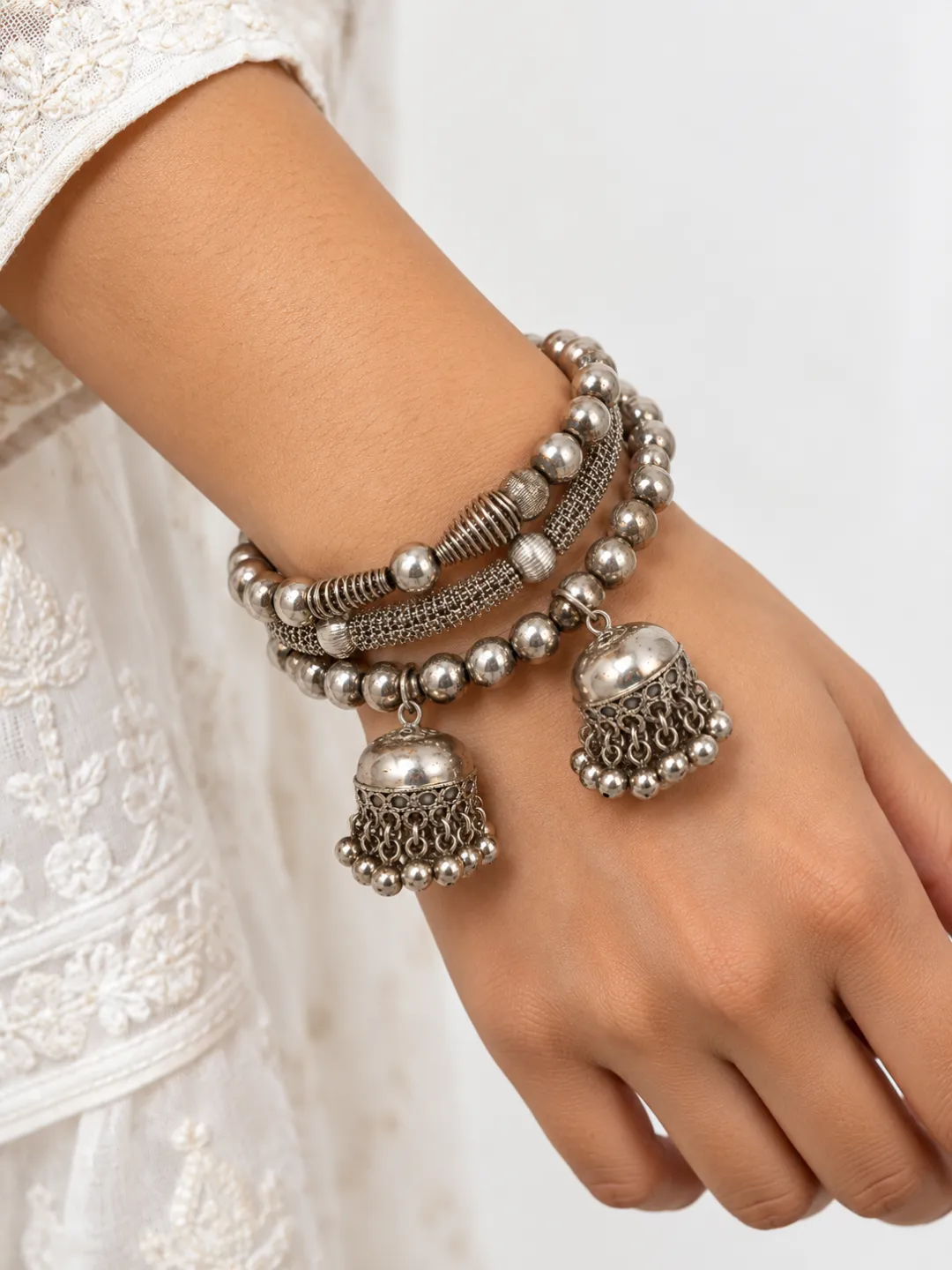Coil Bracelet with Jhumka Drops — worn on the wrist