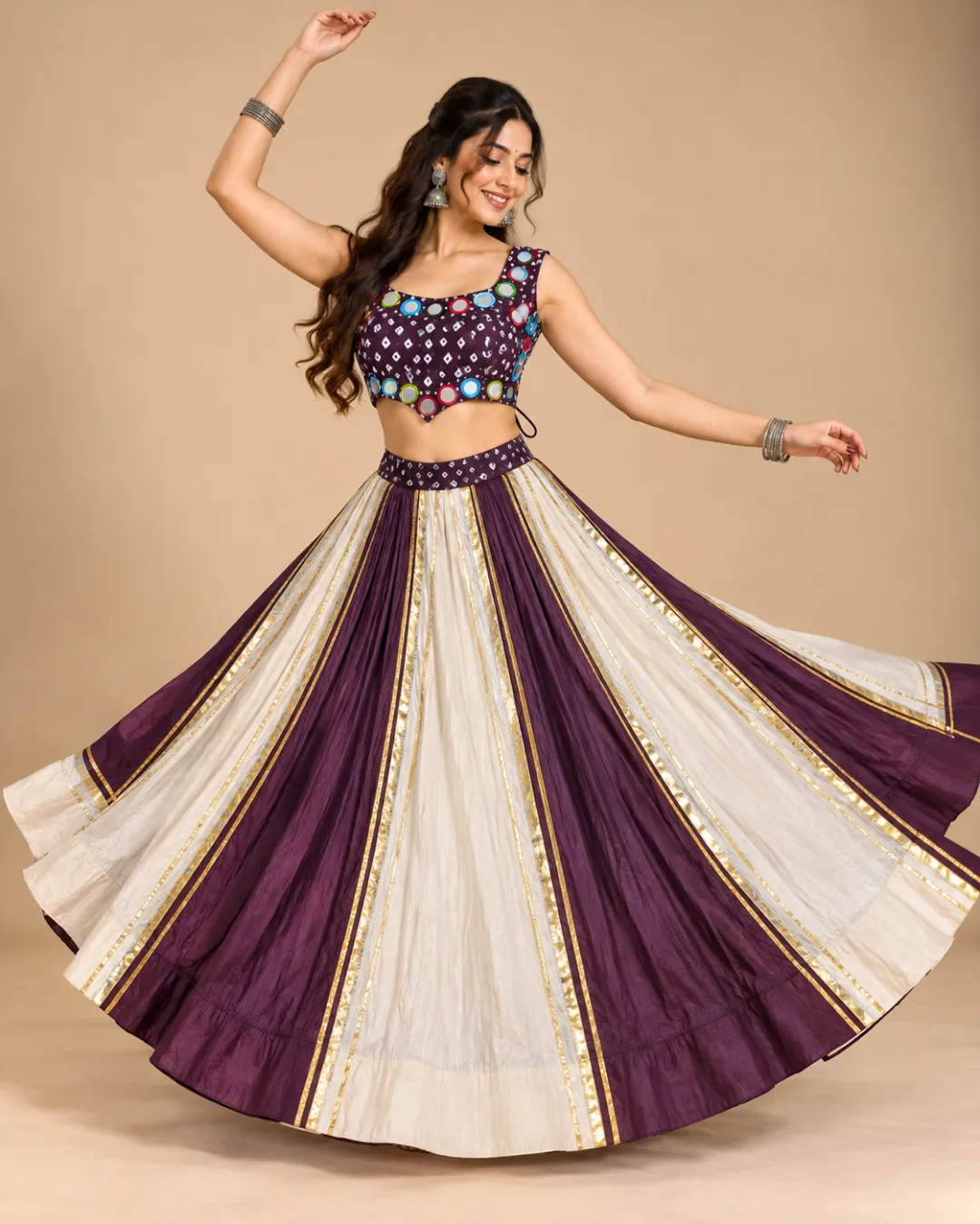 Plum & Ivory Panelled Lehenga with Mirror Work Choli — mid-turn with the gota seams fanning out