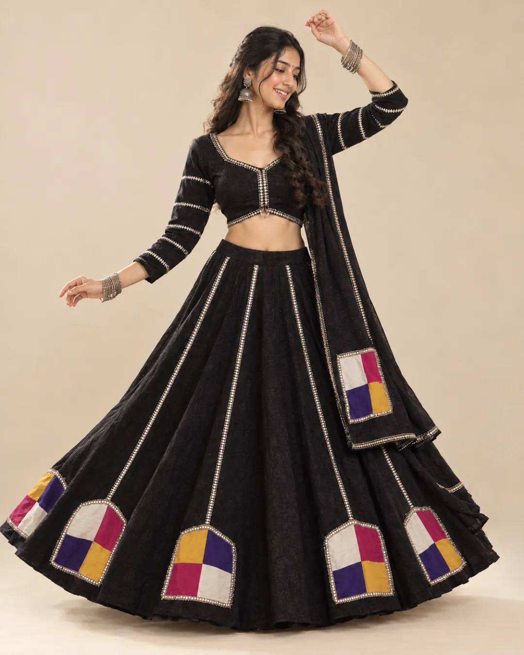 Black Lehenga with Four-Colour Patchwork and Gota Trim — mid-turn with the patches opening out
