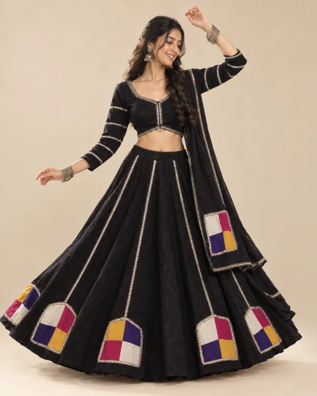 Black Lehenga with Four-Colour Patchwork and Gota Trim — mid-turn with the patches opening out